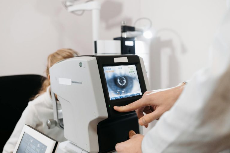 Close-up of an ophthalmologist using a device for an eye exam in a medical clinic setting.
